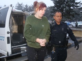 Samantha Pederson of High River is taken into the Okotoks Provincial Courthouse for an appearance in connection with charges alleging sexual exploitation activities involving local teens.