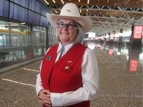 White Hat volunteer Linda Ehman is ready to greet travellers Monday at the new international terminal at Calgary's airport.