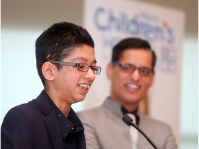 Aizad Bilal, the 2016-2017 Champion Child for the Alberta Children's Hospital Foundation smiles alongside his father Bilal Tanweer after being introduced in a ceremony at the hospital Friday October 28, 2016. He was severely injured, including having every bone in his face broken, when he was hit by a truck five years ago. The Champion is the ambassador for the thousands and kids and their families cared for by the hospital each year. (Ted Rhodes/ Postmedia Calgary)