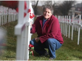 Diane Dallaire stops at the cross dedicated to her son Kevin Dallaire Monday October 31, 2016 at the Field of Crosses on Memorial Drive. Kevin Dallaire died in Afghanistan in 2006. She places poppies at the crosses of all the Southern Alberta soldiers who died in the conflict.
