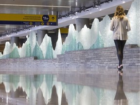 The Glacier Wall, an art piece by Michael Mailhot, in the arrivals area of the new International Terminal at Calgary Airport as seen on an advance tour Monday October 3, 2016. The work is part of the Rhythms of the Landscape collection of sense of place works throughout the terminal.  The terminal, serving US and International flights, is set to open at the end of October. (Ted Rhodes/Postmedia Calgary)