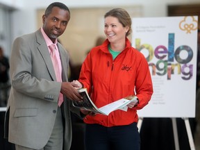 Jean Claude Munyezamu of Soccer Without boundaries and Renee MacKillop of The Alex Community Food Program leaf through Vital Signs at the Calgary Foundation's annual release of the report Tuesday October 4, 2016 at the Remington YMCA.