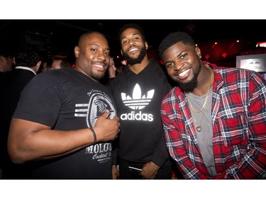 Former Calgary Stampeder Nik Lewis, along with new Montreal Alouettes teammates, Brandon Rutley, right, and BJ Cunningham, centre, at the annual Eric Francis Pizza Pigout Wednesday night October 19, 2016 at Cowboys.