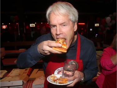 Crazy Canuck Canadian ski legend Ken Read tries out a slice at the annual Eric Francis Pizza Pigout Wednesday night October 19, 2016 at Cowboys.