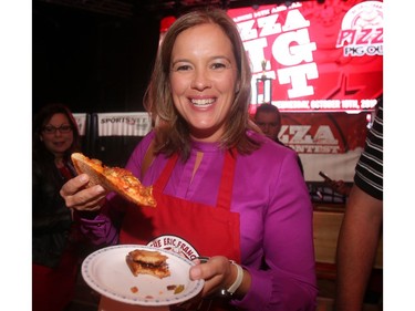 Canadian Olympic hockey star Cassie Campbell tries out a slice at the annual Eric Francis Pizza Pigout Wednesday night October 19, 2016 at Cowboys.