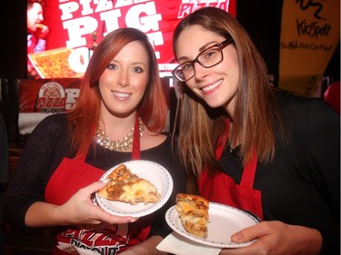 Kristina Shields, left, and Megan Armitage of sponsor Truman Insurance, try out the pizza offerings at the annual Eric Francis Pizza Pigout Wednesday night October 19, 2016 at Cowboys.