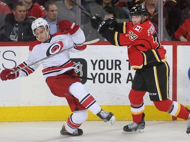 Micheal Ferland of the Calgary Flames takes Noah Hanifin of the Carolina Hurricanes off his stride in the third period at the Saddledome Thursday night October 19, 2016.