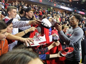 The Toronto Raptors' DeMar DeRozan signs autographs for fans before the NBA preseason game against the Denver Nuggets at the Scotiabank Saddledome in Calgary on Monday Oct. 3, 2016.  Gavin Young/Postmedia