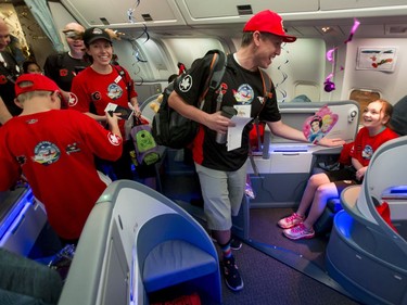 Chris Dingle of Dreams Take Flight happily boards a flight at the Calgary International Airport on Wednesday, Oct. 19, 2016. Dreams Take Fight Calgary took 150 kids deserving a break from difficult situations for a one-day trip to the Magical Kingdom. It was Air Canada's 24th year for its charity event. Lyle Aspinall/Postmedia Network