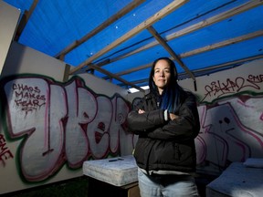 Chrissy Oliver stands inside one of many tarp-covered rooms in the sprawling haunted house filling her entire yard at 117 Chapalina Cl SE  in Calgary, Alta., on Wednesday, Oct. 26, 2016. Bylaw officials are telling her to remove the tarps that cover most of the annual Halloween attraction, but Oliver and her family are resisting since the tarps protect props and provide proper ambience. Lyle Aspinall/Postmedia Network