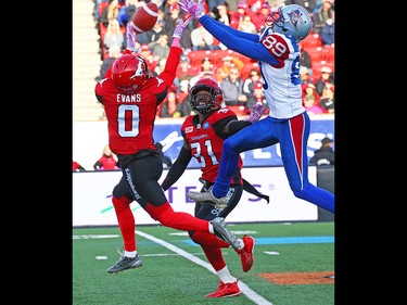 The Calgary Stampeders Ciante Evans looks to grab the ball from the hands of the Montreal Alouettes' Duron Carter during CFL action at McMahon Stadium in Calgary on Saturday October 15, 2016. Gavin Young/Postmedia