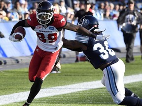 Calgary Stampeders' receiver DaVaris Daniels eludes Toronto Argonauts' defensive back Thomas Gordon for a touchdown during first half CFL action in Toronto, Monday, October 10, 2016.