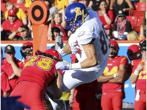 The U of C Dino's Hunter Turnbull makes a big tackle during game action against UBC at McMahon Stadium in Calgary, on September 9, 2016.