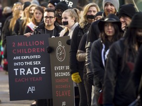 Demonstrators walk in the A21 Walk for Freedom in downtown Calgary, Alta., on Saturday, Oct. 15, 2016. About 100 people were part of the walk, one of 270 such events in 40 countries over 24 hours in a campaign against human trafficking. Lyle Aspinall/Postmedia Network