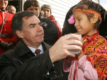Calgary-10-20-06- Minister of Indian Affairs, Jim Prentice and Amber Ear, 6, taste water from the new  Eden Valley water treatment plant during the opening ceremonies on Friday. Photo Credit Leah Hennel/Calgary Herald for City story Kerry Williamson