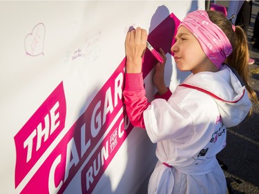 Electra Papadopoulou, 8, signs the Wall of Hope during the Canadian Breast Cancer Foundation CIBC Run for the Cure at Southcentre Mall in Calgary, Alta., on Sunday, Oct. 2, 2016.