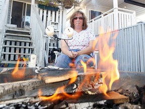 Marg Roseneder roasts marshmallows on her backyard fire pit. A proposal before council calls for spark guards.