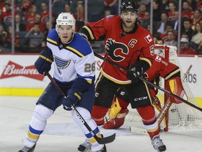 Crystal Schick/ Calgary Herald  CALGARY, AB -- Calgary Flames captain Mark Giordano battles St. Louis Blues Paul Stastny during game action at the Saddledome in Calgary, on October 13, 2015. --   (Crystal Schick/Calgary Herald) (For Sports story by  TBA)  00068663A