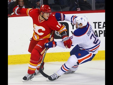 Calgary Flames Matthew Tkachuk battles against Edmonton Oilers Leon Draisaitl during NHL hockey in Calgary, Alta., on Friday, October 14, 2016. AL CHAREST/POSTMEDIA