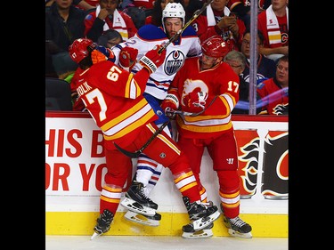 Edmonton Oilers Eric Gryba collides with Michael Frolik and Lance Bouma of the Calgary Flames during NHL hockey in Calgary, Alta., on Friday, October 14, 2016. AL CHAREST/POSTMEDIA