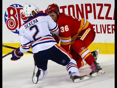 Calgary Flames Troy Brouwer collides with Andrej Sekera  of the Edmonton Oilers during NHL hockey in Calgary, Alta., on Friday, October 14, 2016. AL CHAREST/POSTMEDIA