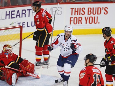 Calgary Flames goalie Brian Elliott, Mark Giordano, Dennis Wideman and Lance Bouma reactc after giving up a goal to Marcus Johansson the Washington Capitals during NHL hockey in Calgary, Alta., on Sunday, October 30, 2016. AL CHAREST/POSTMEDIA