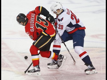 Calgary Flames Johnny Gaudreau battle for a loose puck against  Lars Eller of the Washington Capitals during NHL hockey in Calgary, Alta. on Sunday October 30, 2016.