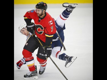 Calgary Flames T. J. Brodie collides with Tom Wilson of the Washington Capitals during NHL hockey in Calgary, Alta., on Sunday, October 30, 2016.