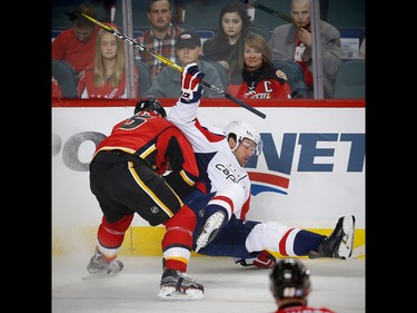 Calgary Flames Mark Giordano battles against Justin Williams of the Washington Capitals during NHL hockey in Calgary, Alta., on Sunday, October 30, 2016. AL