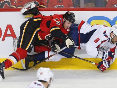Calgary Flames Matt Stajan collides with Alex Ovechkin of the Washington Capitals during NHL hockey in Calgary, Alta., on Sunday, October 30, 2016.