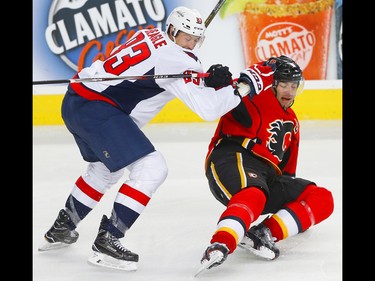 Calgary Flames Mark Giordano and Washington Capitals Jay Beagle battle for a loose puck during NHL hockey in Calgary, Alta. on Sunday October 30, 2016.