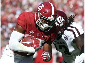 Alabama running back Joshua Jacobs (25) is knocked out of bounds by Texas A&M defensive lineman Reggie Chevis (13) during the first half of an NCAA college football game in Tuscaloosa, Ala., Saturday, Oct. 22, 2016. (Erin Nelson/The Tuscaloosa News via AP) ORG XMIT: ALTUS901