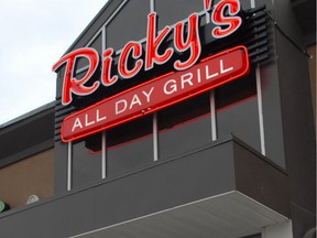 Kyler Moore, managing partner of Ricky's All Day Grill, left, and co-owner Robert Hart celebrate the official soft opening of their restaurant on Tuesday, Oct. 15, 2013 at their new location on 99 Street, next to the Superstore in Grande Prairie Alberta. In honour of their opening, the co-owners donated $3,100 to Kev's Kids, a local charity. JOCELYN TURNER/DAILY HERALD-TRIBUNE/QMI AGENCY