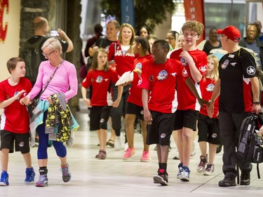 Lucky kids walk to board a Dreams Take Flight trip at the Calgary International Airport on Wednesday, Oct. 19, 2016. Dreams Take Fight Calgary took 150 kids deserving a break from difficult situations for a one-day trip to the Magical Kingdom. It was Air Canada's 24th year for its charity event. Lyle Aspinall/Postmedia Network