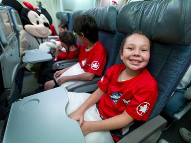 Marissa McGillis, 10, happily waits for the departure of her flight at the Calgary International Airport on Wednesday, Oct. 19, 2016. Dreams Take Fight Calgary took 150 kids deserving a break from difficult situations for a one-day trip to the Magical Kingdom. It was Air Canada's 24th year for its charity event. Lyle Aspinall/Postmedia Network