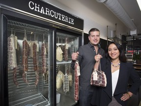 Karen Kho, right, and Dave Sturies, co-owners and proprietors Empire Provisions, pose for a photo with a sample of their meats in Una Takeaway on 17th Avenue S.W.