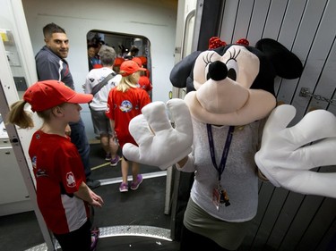 Minnie Mouse greets kids as they board a flight at the Calgary International Airport on Wednesday, Oct. 19, 2016. Dreams Take Fight Calgary took 150 kids deserving a break from difficult situations for a one-day trip to the Magical Kingdom. It was Air Canada's 24th year for its charity event. Lyle Aspinall/Postmedia Network