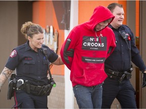 Police arrest a male outside of the A&W near the intersection of 24 St and Southland Dr SW in Calgary, Alta., on Sunday, Oct. 30, 2016.