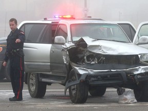 Police investigate at the scene of a two car accident on 52 St and Erin Woods Dr SE in Calgary, Alta on Saturday October 8, 2016. A stolen SUV allegedly hit another car in the intersection and the driver of the the stolen SUV then fled on foot, but was caught a short time later.  The passenger in the vehicle that was hit was takent to hospital with non-life threatening injuries. Jim Wells//Postmedia