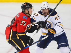 Calgary Flames Micheal Ferland battles against Zach Bogosian of the Buffalo Sabres during NHL hockey in Calgary, Alta., on Tuesday, October 18, 2016.