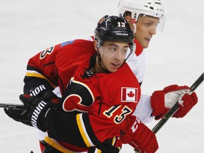 Johnny Gaudreau and Jay McClement of the Carolina Hurricanes battle for position during a game in Calgary.