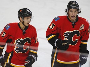 Calgary Flames Johnny Gaudreau and Sean Monahan during a break in play while facing the Carolina Hurricanes in NHL hockey in Calgary, Alta. on Thursday October, 20, 2016. AL CHAREST/POSTMEDIA