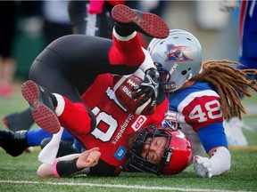 Montreal Alouettes Bear Woods brings down Bo Levi Mitchell of the Calgary Stampeders during CFL football in Calgary, Alta., on Saturday, October 15, 2016.