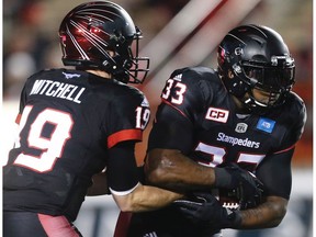 Calgary Stampeders quarterback, Bo Levi Mitchell, hands the ball off to running back Jerome Messam, during a game against the Toronto Argonauts in Calgary, Alta., on Friday, October 21, 2016.