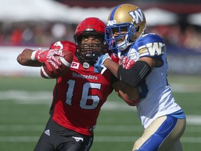 Stampeders Marquay McDaniel (L) battles Blue Bombers Johnny Adams (R) during CFL action between the Calgary Stampeders and the Winnipeg Blue Bombers in Calgary, Alta.. on Saturday September 24, 2016. Jim Wells/Postmedia