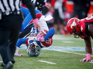 Calgary Stampeders Micah Johnson brings down quarterback Rakeem Cato of the Montreal Alouettes during CFL football in Calgary, Alta., on Saturday, October 15, 2016. AL CHAREST/POSTMEDIA