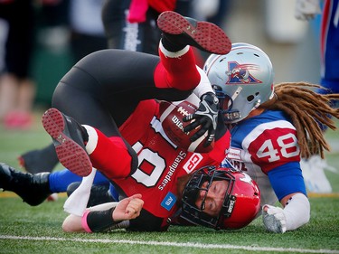 Montreal Alouettes Bear Woods brings down Bo Levi Mitchell of the Calgary Stampeders during CFL football in Calgary, Alta., on Saturday, October 15, 2016. AL CHAREST/POSTMEDIA