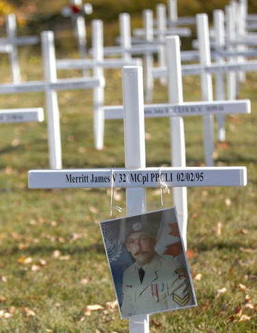 A photo of Jim Merritt was placed on his cross by his brother Steve during the set-up at the Field of Crosses Memorial Project in Calgary, Alta on Saturday October 22, 2016 near Memorial Dr and Centre St NW. Starting November 1st to November 11th, over 3,200 crosses are being displayed on a 5 acre city park in military cemetery formation to memorialize southern Alberta soldiers who were killed in action.  Each cross is inscribed with the name, age at death, rank, regiment and date of death of a soldier who lost his or her life in a foreign land, fighting for the freedoms we all enjoy today. Jim Wells/Postmedia