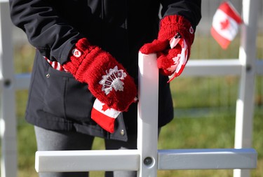 A volunteer places a Canadian flag on a cross during the set-up at the Field of Crosses Memorial Project in Calgary, Alta on Saturday October 22, 2016 near Memorial Dr and Centre St NW. Starting November 1st to November 11th, over 3,200 crosses are being displayed on a 5 acre city park in military cemetery formation to memorialize southern Alberta soldiers who were killed in action.  Each cross is inscribed with the name, age at death, rank, regiment and date of death of a soldier who lost his or her life in a foreign land, fighting for the freedoms we all enjoy today. Jim Wells/Postmedia
