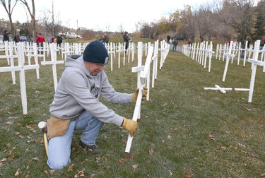 Volunteers work during the set-up at the Field of Crosses Memorial Project in Calgary, Alta on Saturday October 22, 2016 near Memorial Dr and Centre St NW. Starting November 1st to November 11th, over 3,200 crosses are being displayed on a 5 acre city park in military cemetery formation to memorialize southern Alberta soldiers who were killed in action.  Each cross is inscribed with the name, age at death, rank, regiment and date of death of a soldier who lost his or her life in a foreign land, fighting for the freedoms we all enjoy today. Jim Wells/Postmedia
